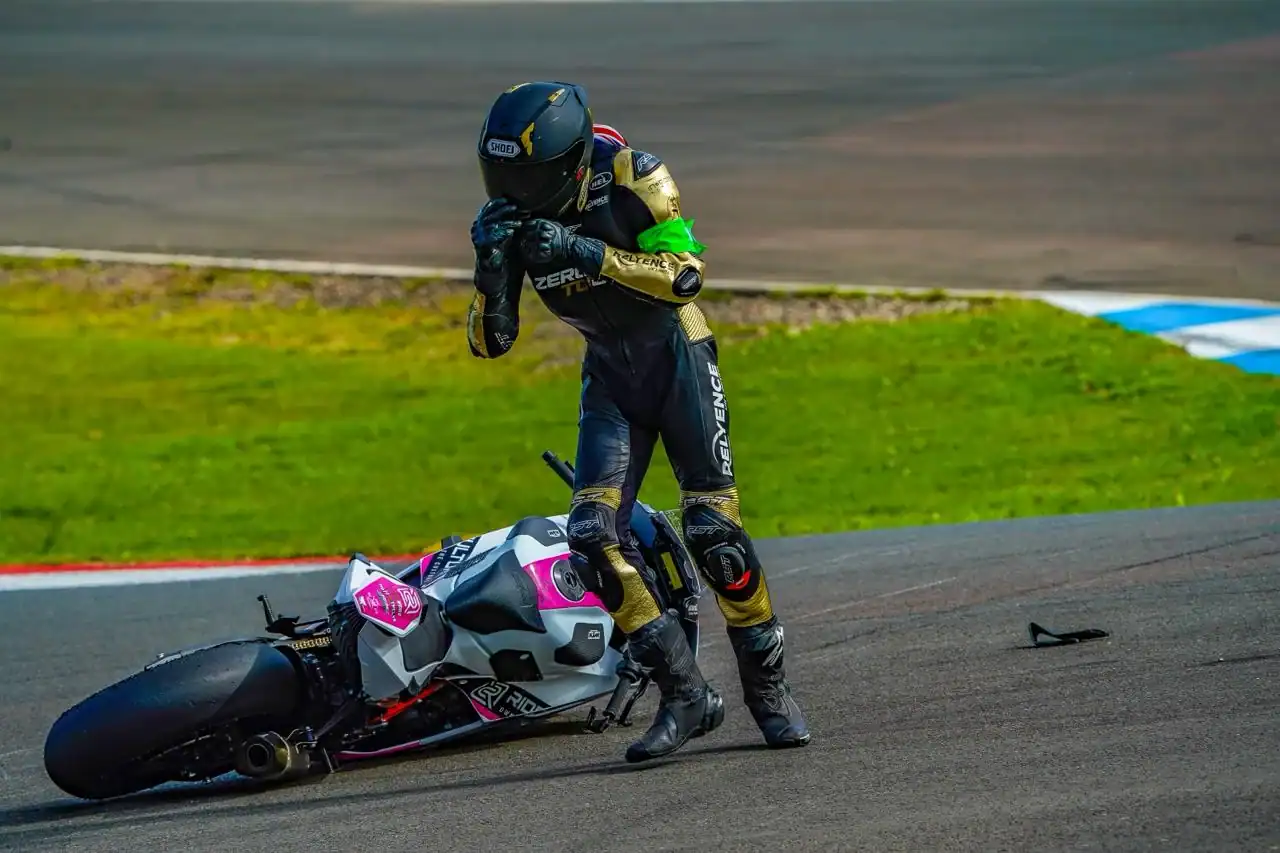 RND 7 Knockhill: The KTM Makes an Impression 1 Evan Brailsford, wearing a green endurance armband, standing over the fallen Ride Culture Racing KTM 990 RC R at Knockhill.