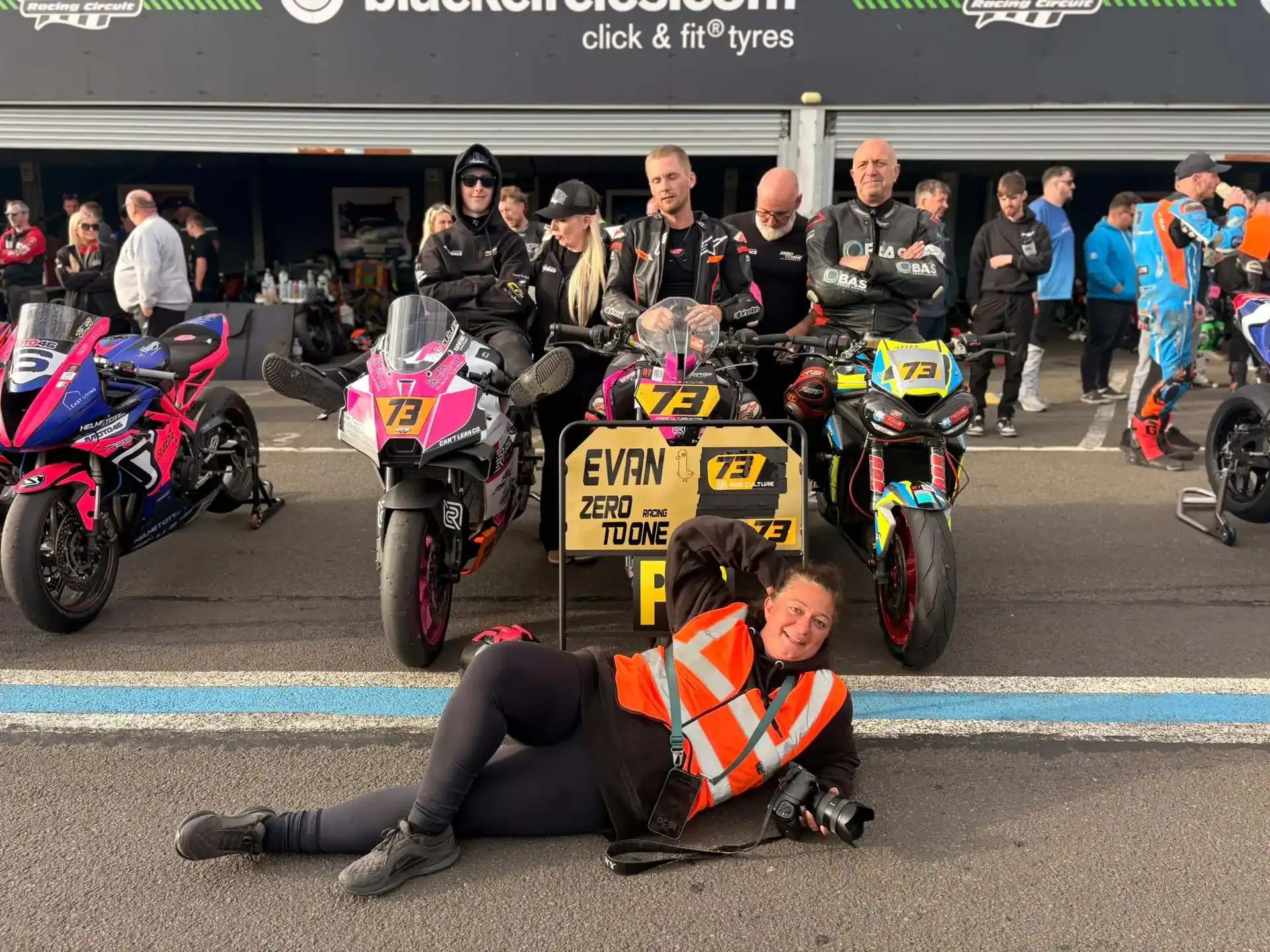 RND 7 Knockhill: The KTM Makes an Impression 2 Evan Brailsford with Ride Culture Racing teammates and Evan's number 73 KTM 990 RC R in the Knockhill paddock, beside a pit board reading Evan, Zero To One Racing, 73, Ride Culture.
