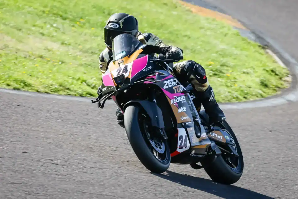 Evan Brailsford leaning the number 24 Zero To One Racing KTM 990 RC R into a corner at Anglesey during Race 23.
