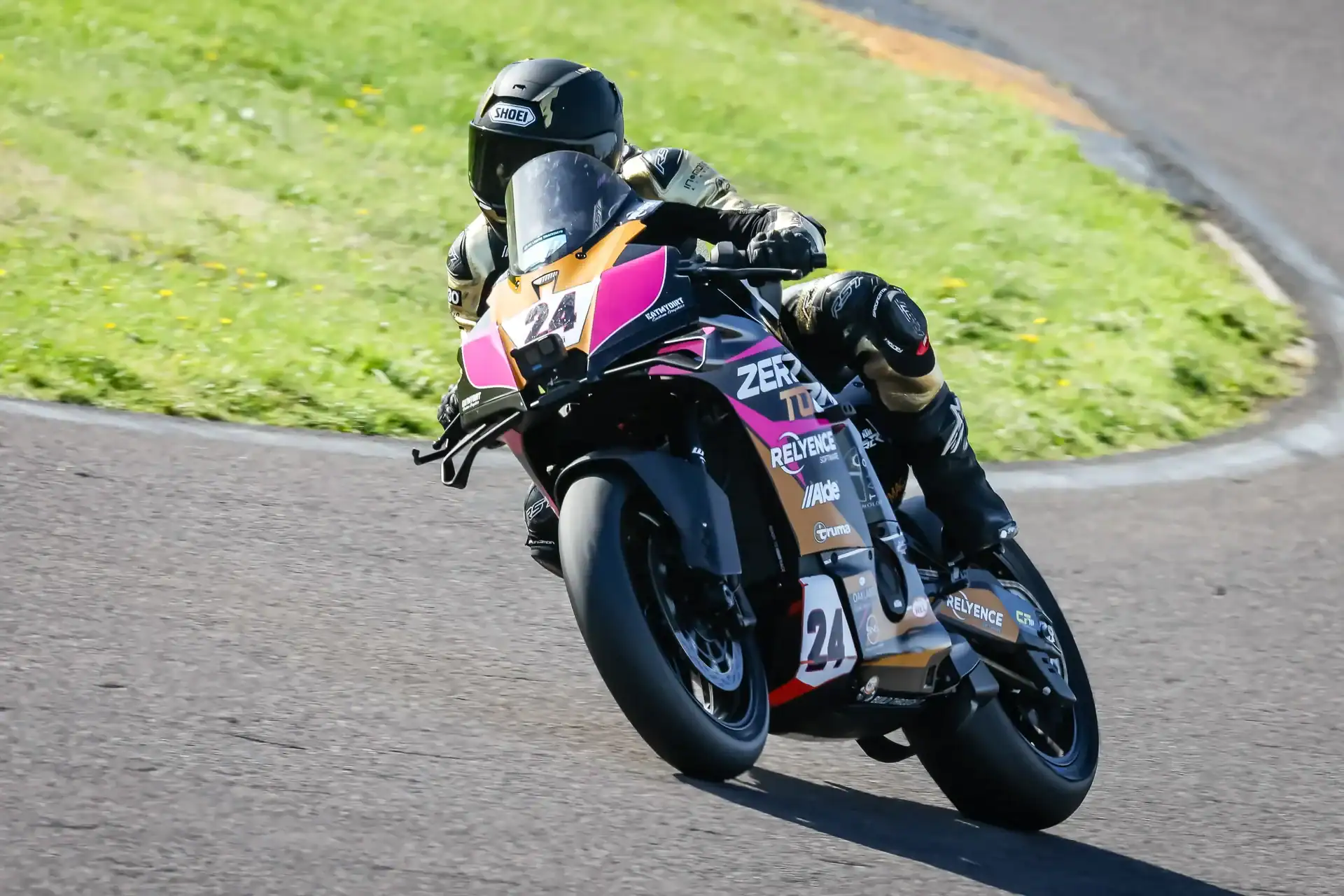 Evan Brailsford leaning the number 24 Zero To One Racing KTM 990 RC R into a corner at Anglesey during Race 23.