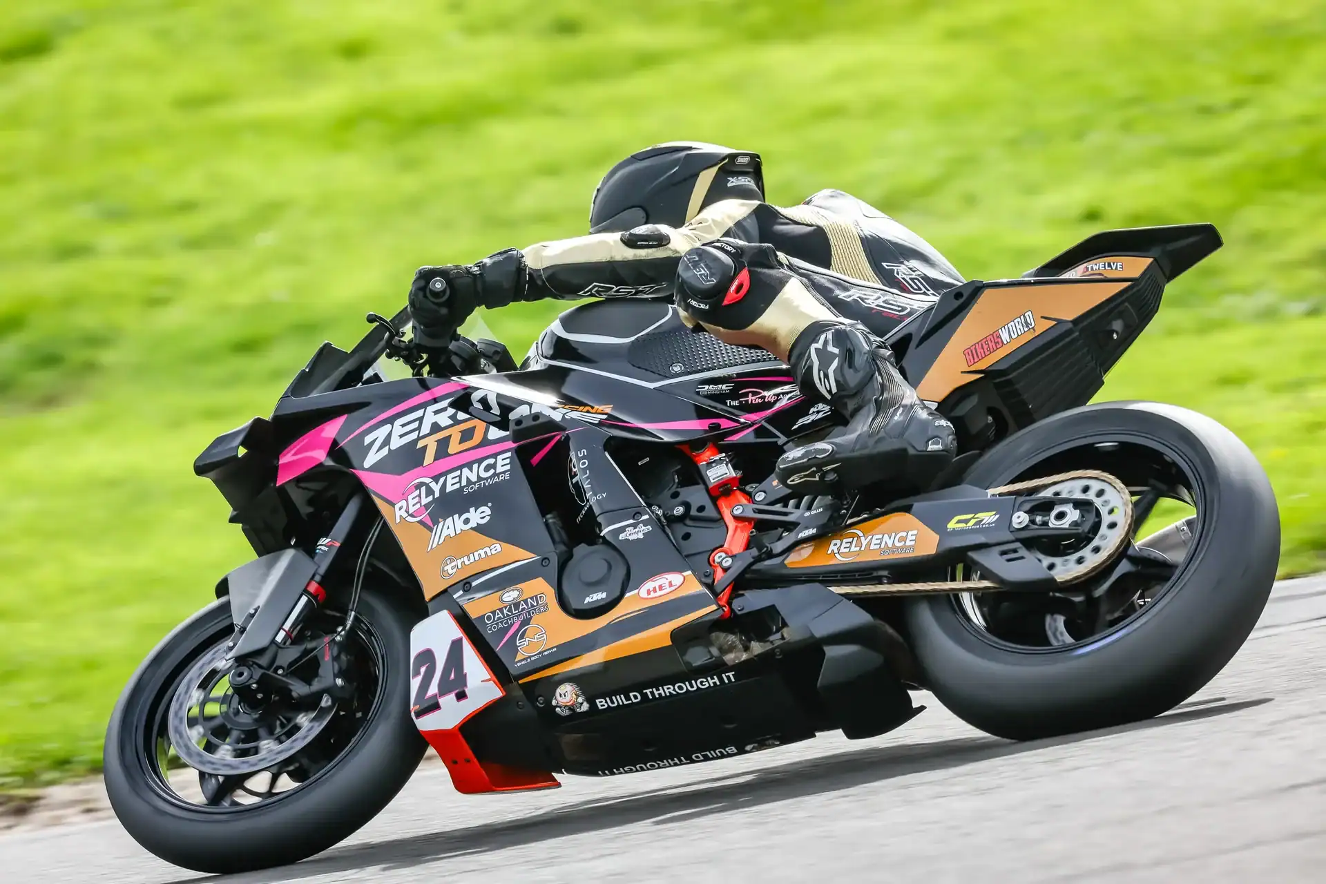 RND 8 Anglesey Coastal 2 Side view of Evan Brailsford cornering the number 24 KTM 990 RC R in its pink, gold and black livery during Saturday's Race 7 at Anglesey.