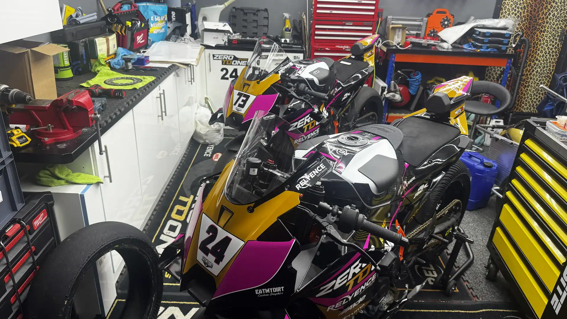 KTM 990 RC R Acquisition and New Livery 5 Two KTM 990 RC Rs side by side in the Zero To One Racing garage, numbers 24 and 73, both finished in the new pink, gold and black livery.